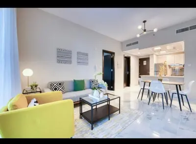 a living room with a couch and a table at 012 - Dubai South in Dubai