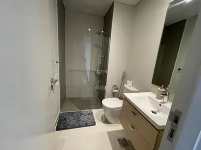 a bathroom with a shower and a toilet and a sink at 014 - Damac Hills in Dubai