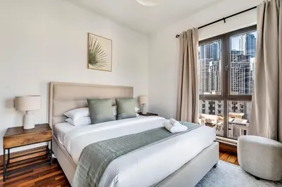 a bedroom with a large bed and a window at GuestReady - Downtown retreat with city views in Dubai