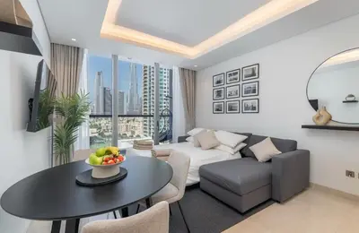 a living room with a couch and a table at Luxury Apt with Full Burj Khalifa Skyline Views in Dubai