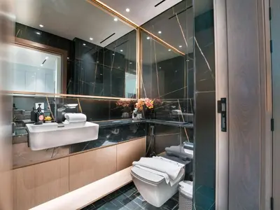 a bathroom with a sink and a toilet and a mirror at EasyGo- Stylish 1BDR with view and astonishing Facilities JVC in Dubai