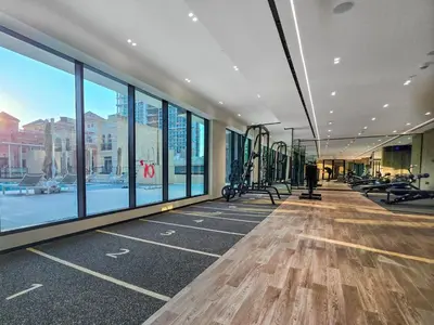 a gym with treadmills and exercise equipment in a building at EasyGo- Stylish 1BDR with view and astonishing Facilities JVC in Dubai