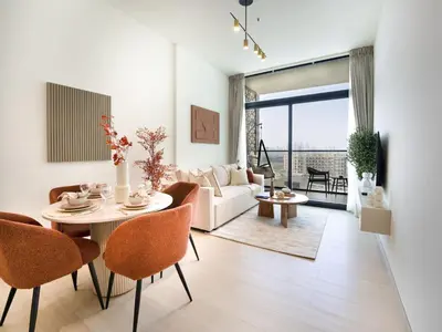a living room with a table and chairs and a couch at EasyGo- Stylish 1BDR with view and astonishing Facilities JVC in Dubai