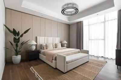 a bedroom with a large bed and a plant at SIMPLY COMFORT Apartments at Nobles Tower Luxury Burj View in Dubai