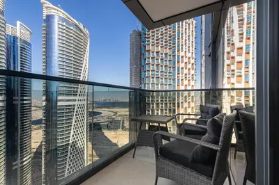 a balcony with chairs and a view of the city at SIMPLY COMFORT Apartments at Nobles Tower Luxury Burj View in Dubai