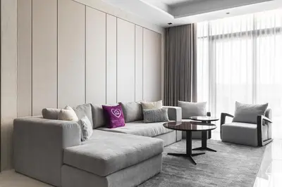 a living room with a couch and a chair at SIMPLY COMFORT Apartments at Nobles Tower Luxury Burj View in Dubai
