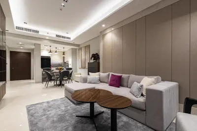 a living room with a couch and a table at SIMPLY COMFORT Apartments at Nobles Tower Luxury Burj View in Dubai