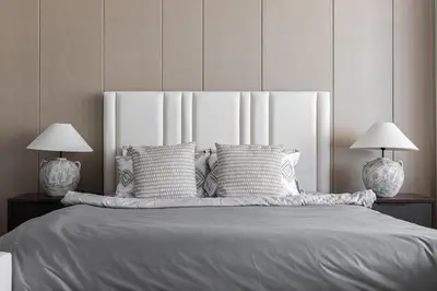 a bedroom with a large bed with two lamps at SIMPLY COMFORT Apartments at Nobles Tower Luxury Burj View in Dubai