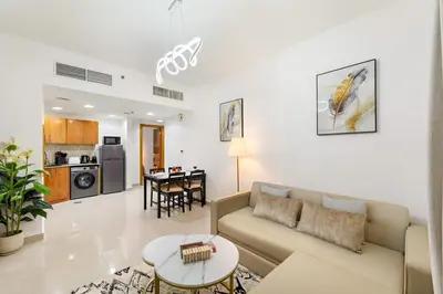 a living room with a couch and a table at Luxury 1BR with Lake View Near Downtown Balcony and Pool Access in Dubai