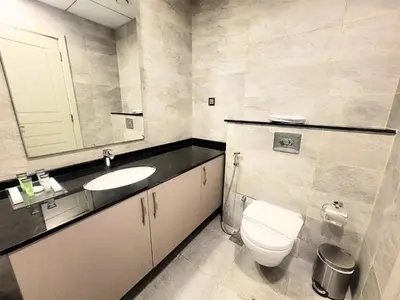 a bathroom with a toilet and a sink and a mirror at Polo Residence C1 - Blue Ocean Holiday Homes in Dubai