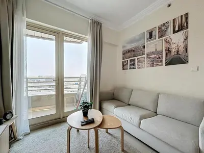 a living room with a couch and a table at Marina 1 Bedroom Gem in Dubai