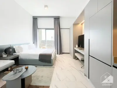 a hotel room with a bed and a large window at Tranquil Studio Getaway in Dubai's MAG 920 in Dubai