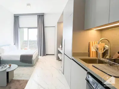 a hotel room with a bed and a kitchen at Tranquil Studio Getaway in Dubai's MAG 920 in Dubai