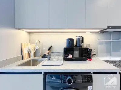 a kitchen counter with a coffee maker and a dishwasher at Tranquil Studio Getaway in Dubai's MAG 920 in Dubai