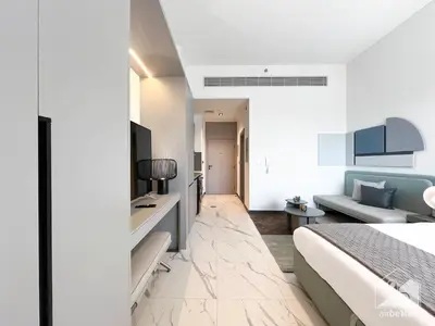 a hotel room with a bed and a couch at Stylish Studio Getaway in Dubai's MAG 920 in Dubai
