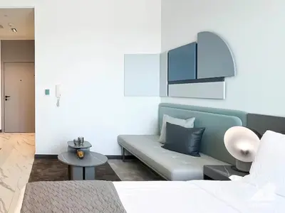 a living room with a couch and a table at Stylish Studio Getaway in Dubai's MAG 920 in Dubai