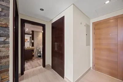 a hallway with wooden doors in a house at Burj Khalifa View Apartment with Balcony Downtown Dubai in Dubai