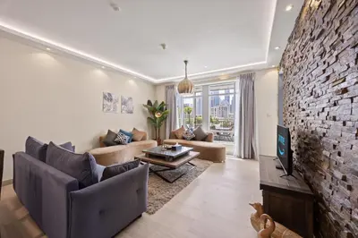 a living room with a brick wall at Burj Khalifa View Apartment with Balcony Downtown Dubai in Dubai