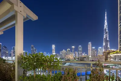 a view of a city skyline at night at Burj Khalifa View Apartment with Balcony Downtown Dubai in Dubai