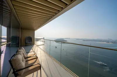 a balcony on a cruise ship looking out at the water at Homes & Beyond I Pristine 2BR with Waterfront view in Dubai