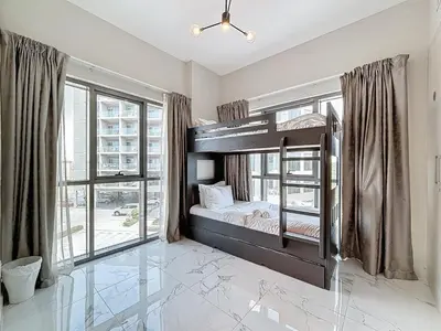 a bedroom with a bunk bed and a large window at Family friendly 2-bedroom in Dubai