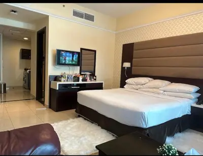 a bedroom with a large bed and a television at Cozy Dubai Marina Suite in Dubai