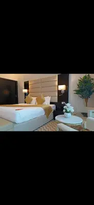 a bedroom with a large bed and two tables at Cozy Dubai Marina Suite in Dubai