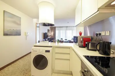 a kitchen with a washer and dryer in a room at Partial Burjkhalifa View from Balcony in Dubai Mall-Studio King Bed in Dubai