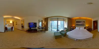 a large hotel room with a bed and a television at Partial Burjkhalifa View from Balcony in Dubai Mall-Studio King Bed in Dubai