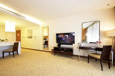 a living room with a television and a desk with a mirror at Partial Burjkhalifa View from Balcony in Dubai Mall-Studio King Bed in Dubai