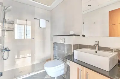 a bathroom with a white toilet and a sink at Cozy 2bd in Dubai Marina in Dubai