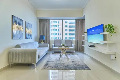 a living room with a couch and a tv at Cozy 2bd in Dubai Marina in Dubai