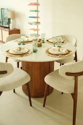 a dining room table with plates and glasses and chairs at Luxury Jumeirah canal front designer stay sleeps4 in Dubai
