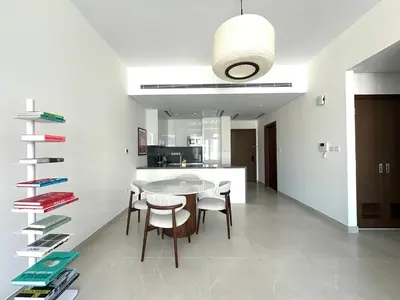 a dining room with a table and chairs and a kitchen at Luxury Jumeirah canal front designer stay sleeps4 in Dubai