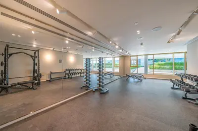 a large room with rows of chairs and a gym at Homes Beyond I Modern 2BR Getaway with Beach Access in Dubai