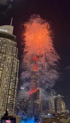 a large fire in a city at night at Souk Al Bahar Dubai Fountain and Burj Khalifa view from the Balcony, 2 mins walk to Dubai Mall by Norbu Holiday Homes in Dubai