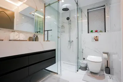 a bathroom with a glass shower and a toilet at Souk Al Bahar Dubai Fountain and Burj Khalifa view from the Balcony, 2 mins walk to Dubai Mall by Norbu Holiday Homes in Dubai