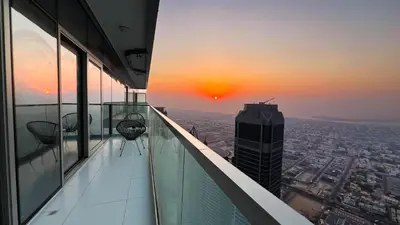 a view from the top of a building with a sunset at KeyRock Living - Luxe Retreat at Paramount in Dubai