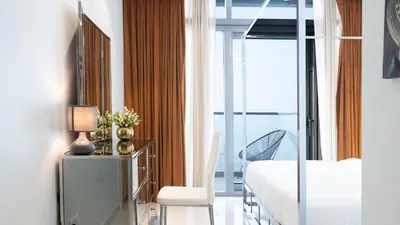 a bedroom with a bed and a tv and a window at KeyRock Living - Luxe Retreat at Paramount in Dubai