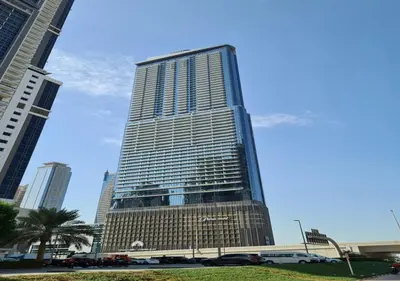a tall building with cars parked in front of it at KeyRock Living - Luxe Retreat at Paramount in Dubai