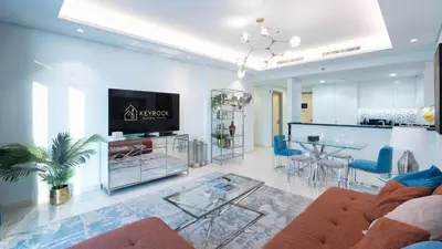 a living room with a couch and a tv and a table at KeyRock Living - Luxe Retreat at Paramount in Dubai