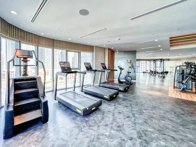 a gym with treadmills and ellipticals in a room at 5 Star Stay, Infinity Pool with Burj Khalifa Views in Dubai