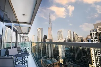 a balcony with chairs and a view of a city at 5 Star Stay, Infinity Pool with Burj Khalifa Views in Dubai