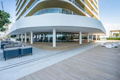 a building with couches and chairs in front of it at Homes Beyond l Relaxing 1BR Oasis with Beach Access in Dubai
