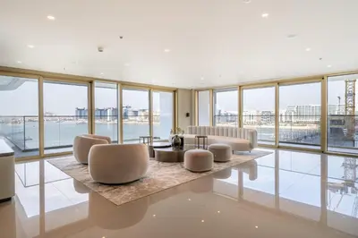 a living room with a lot of windows at Homes Beyond l Relaxing 1BR Oasis with Beach Access in Dubai