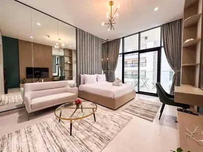 a living room with a bed and a couch and a table at Stylish Studio in the Heart of Al Furjan 20AB4 in Dubai
