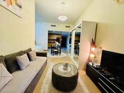 a living room with a couch and a coffee table at Premium Large Studio in Hamilton residency business bay Marasi Drive Dubai in Dubai