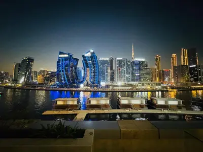 a view of a city skyline at night at Premium Large Studio in Hamilton residency business bay Marasi Drive Dubai in Dubai