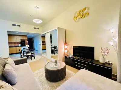 a living room with a couch and a table at Premium Large Studio in Hamilton residency business bay Marasi Drive Dubai in Dubai