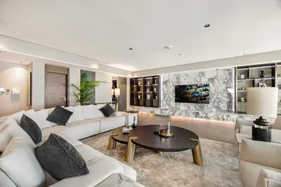 a living room with a white couch and a table at Daniels 3BR at Princess Tower With Full Palm Jumeirah View in Dubai